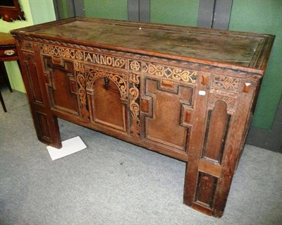 Lot 513 - A joined oak chest, the boarded lid with moulded edge above a carved frieze dated 1691 and...