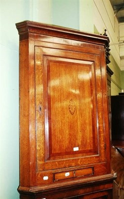 Lot 527 - A George III inlaid oak corner cupboard