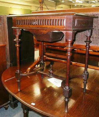 Lot 631 - A continental walnut writing table with work box drawer below