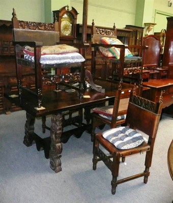 Lot 632 - A Spanish style carved dining table, six matching chairs including two carvers, a sideboard...