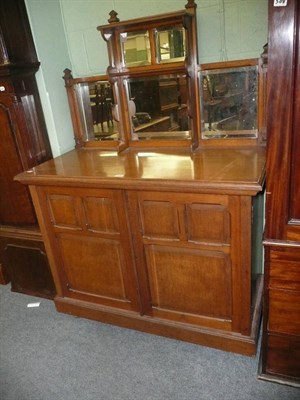 Lot 650 - A light oak side cabinet with mirrored superstructure