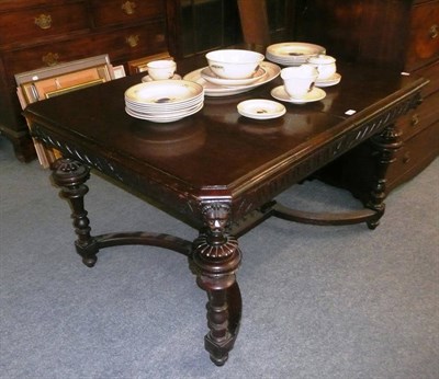 Lot 663 - Large carved oak dining table with leaf