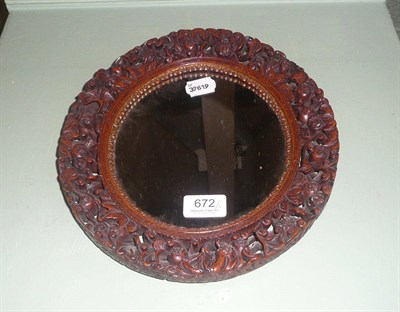 Lot 672 - A pair of oval mirrors with pierced and carved wood frames