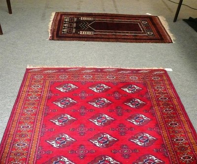 Lot 678 - A Belouch prayer rug and a red ground rug