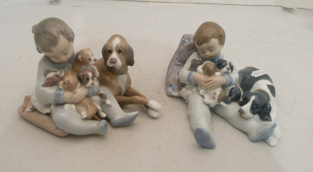 Lot 29 - Two Lladro groups of boys with puppies