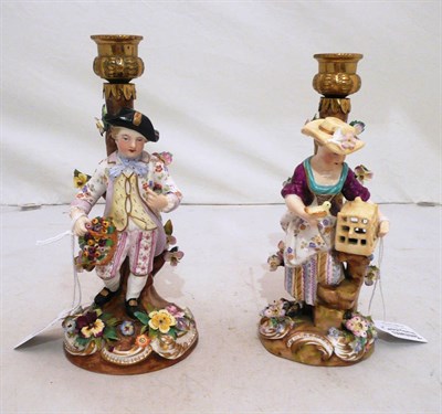 Lot 49 - Pair of porcelain and gilt metal figural candlesticks, one of a young girl with a canary and...
