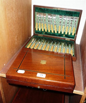 Lot 74 - A set of dessert knives and forks and a cased set of fish knives and forks