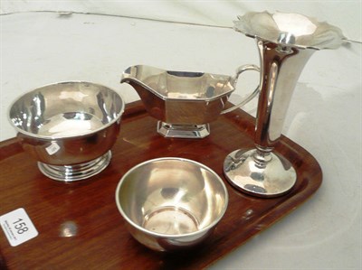 Lot 158 - A loaded silver trumpet vase, a silver sauce boat and two small silver bowls