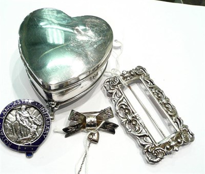 Lot 188 - A silver heart shaped ring box, a silver buckle, a bar brooch and a Lancaster Infirmary badge