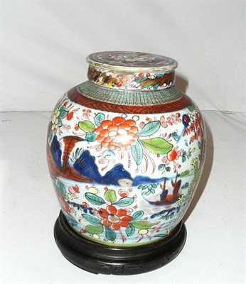 Lot 192 - An 18th century Chinese ginger jar with cover and hardwood stand, with clobbered decoration