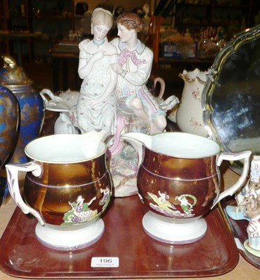 Lot 196 - A Parian coloured figure group and two copper pink lustre jugs