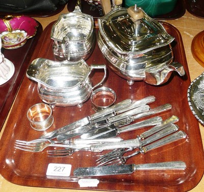Lot 227 - A silver three piece tea service, two napkin rings and a quantity of silver-handled cutlery