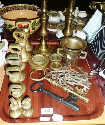 Lot 232 - A set of brass bell weights, various flat weights, pair of brass candlesticks, keys, etc