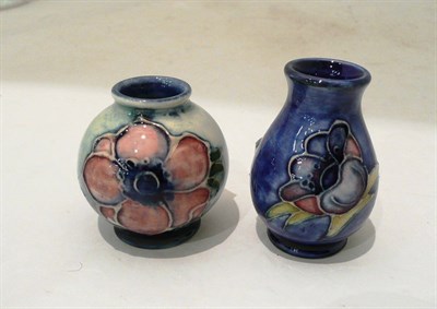Lot 279 - Two Walter Moorcroft 'Anemone' miniature vases on blue grounds