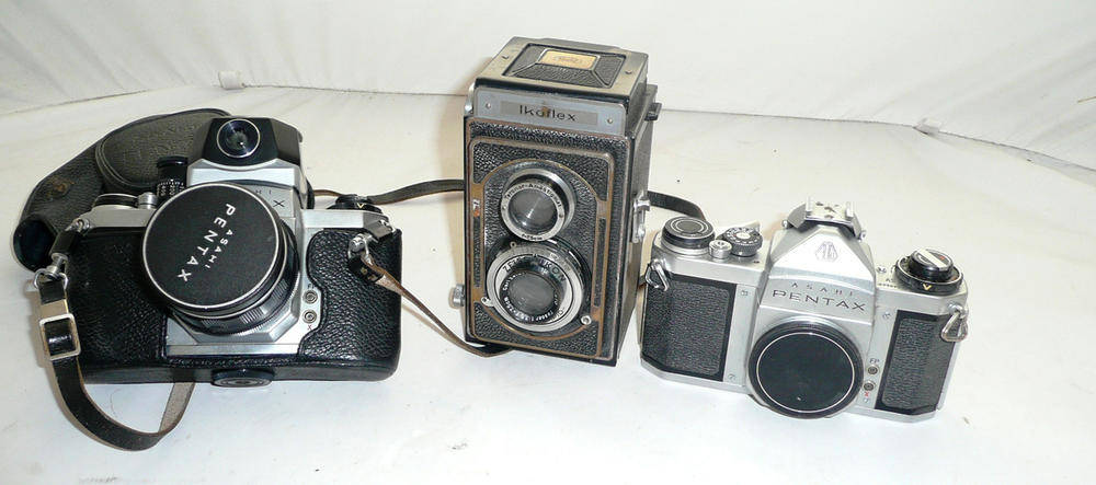 Lot 1188 - Three Cameras - Zeiss Ikoflex twin lens reflex and two Asahi Pentax SV cameras, one with light...