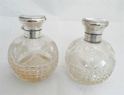 Lot 78 - A pair of glass scent bottles with silver covers