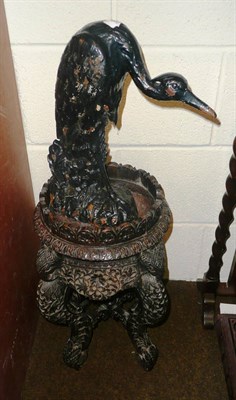 Lot 107 - Carved hardwood stand and a cast iron heron (2)
