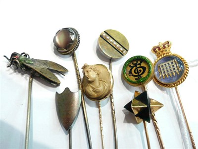 Lot 141 - A stick pin with House of Commons motif, a lava cameo stick pin, a snake motif stick pin, a...