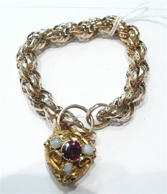 Lot 146 - A pierced bracelet with a garnet and opal padlock fastener