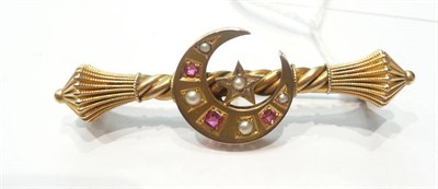 Lot 147 - A bar brooch with crescent and star motif set with seed pearls and rubies
