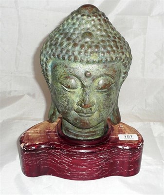 Lot 157 - A bronze Buddha head mounted on a wooden base