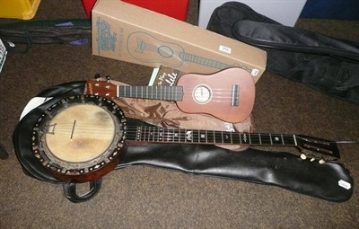 Lot 203 - A five string banjo and two ukuleles (3)