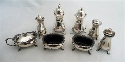 Lot 209 - A set of three silver pepperettes, a pair of salts and a mustard pot, 6.8oz and a pair of...