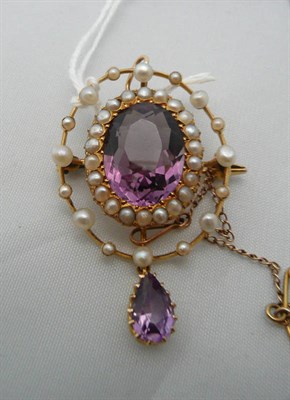 Lot 262 - An amethyst and seed pearl pendant/brooch, circa 1900, stamped '15CT'