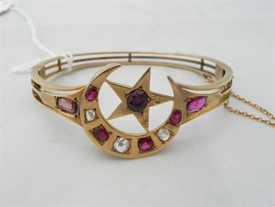 Lot 272 - A bangle with a crescent and star motif set with rose cut diamonds and rubies