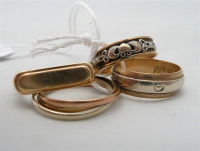 Lot 280 - Four 9ct gold rings including a Russian wedding band, a signet ring and two fancy band rings