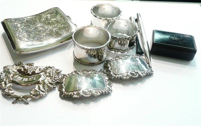 Lot 72 - A silver cigarette case, three silver napkin rings, two silver decanter labels and another, a...