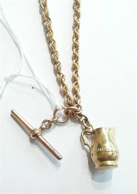Lot 79 - A 9ct gold fancy link watch chain hung with a 9ct gold charm, 33gms