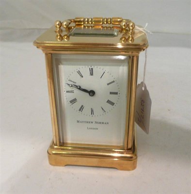 Lot 133 - A brass carriage timepiece signed 'Matthew Norman, London' in fitted box with key