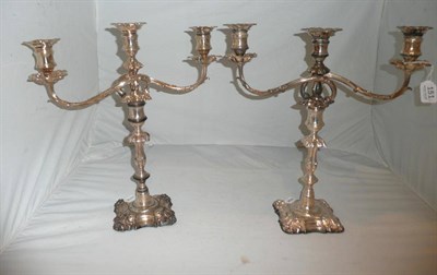 Lot 151 - A pair of silver plated two branch three light candelabra