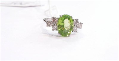 Lot 201 - A 14ct white gold peridot and diamond ring