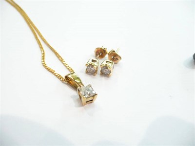 Lot 212 - A princess cut diamond pendant on a curb chain with matching stud earrings