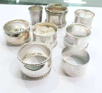 Lot 214 - Seven silver napkin rings and a vodka beaker