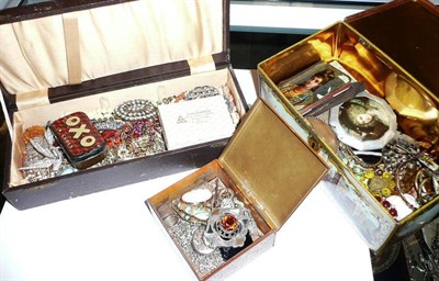 Lot 230 - A tin and a black box containing a quantity of costume jewellery etc