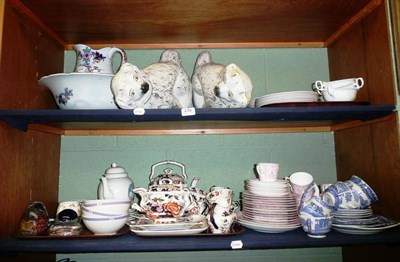 Lot 236 - Two shelves of decorative ceramics, Staffordshire spaniel dogs, wash set, Copeland Spode...