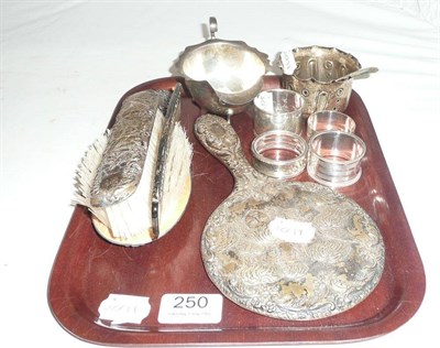 Lot 250 - A tray of small silver items comprising a four piece vanity set, a sugar bowl, a sauce boat and...