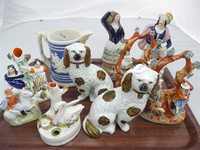 Lot 299 - A pair of Staffordshire spaniels, a pair of Staffordshire arbour groups, a figural vase, a swan pen