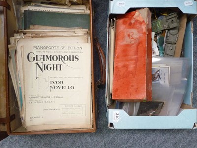 Lot 310 - A box of collectables including a die cast field gun, postcards, etc and a case of sheet music (2)