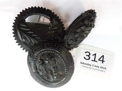 Lot 314 - Three carved jet brooches