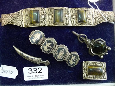 Lot 332 - A Siam bracelet, a filigree tiger's eye bracelet and brooch, a dagger brooch and another