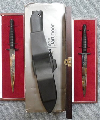 Lot 356 - Two cased commemorative fighting knives and a survival knife (3)