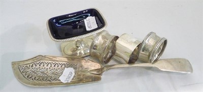 Lot 370 - A Victorian silver fish slice, three napkin rings and a salt