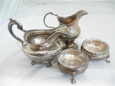 Lot 375 - Two Georgian silver cream jugs and two salts with liners