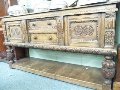 Lot 424 - A carved oak sideboard