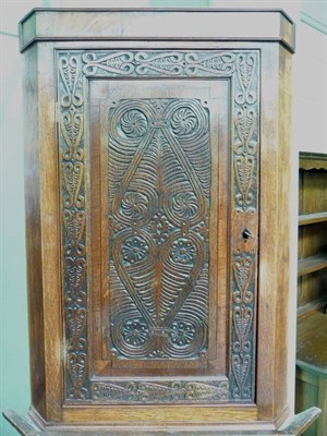 Lot 434 - Carved oak corner cupboard