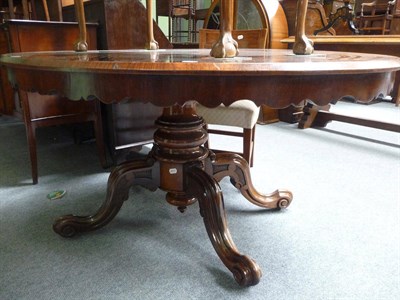 Lot 437 - A rosewood veneered oval-shaped pedestal breakfast table on quadruped supports